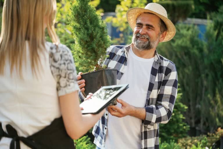 Woman and man are working in the garden together with plants - losangelesgardenpros.com outdoor landscape lighting near me inexpensive landscapers near me